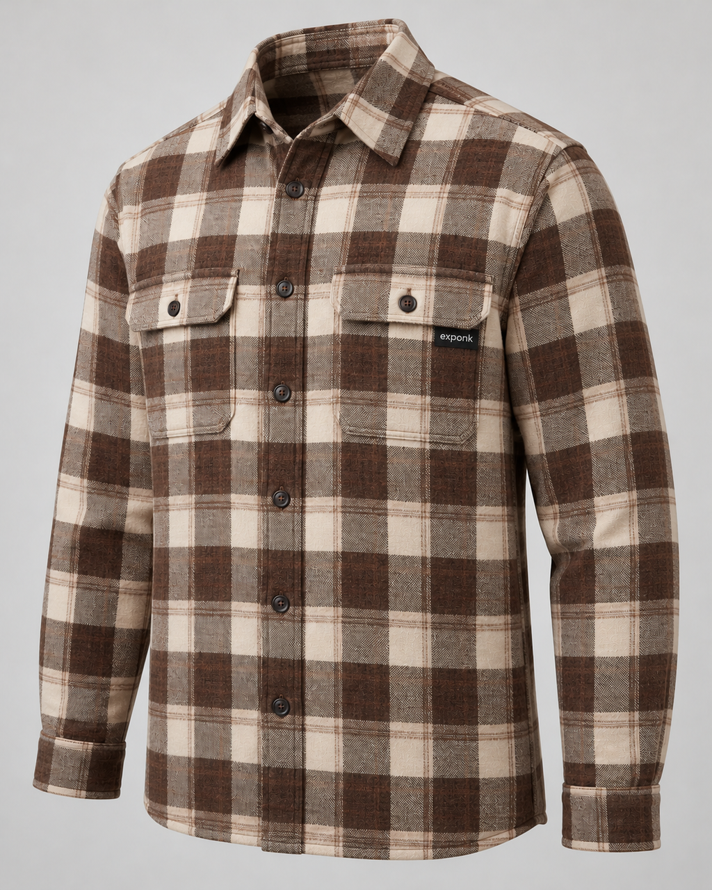 exponk Timber Overshirt in brown check, three-quarter view showing the check pattern, buttoned chest pockets and cuff details.