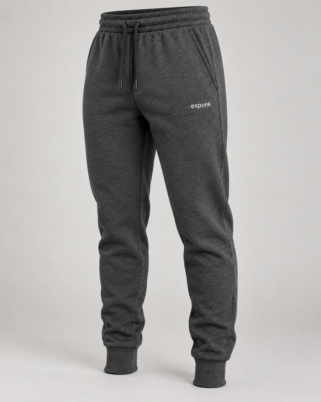 exponk Traverse Winter Joggers in charcoal, angled view showing the drawstring waist, side pockets, tapered fit and cuffed hems.